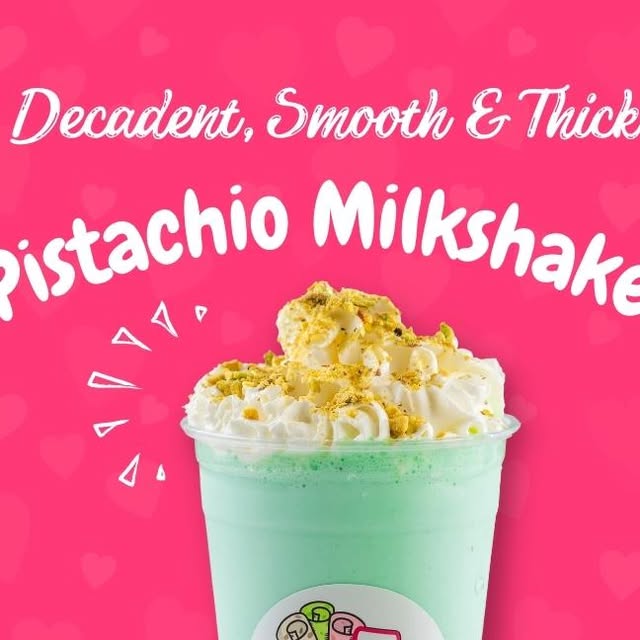 Pistachio milkshake with whipped cream and crushed pistachios