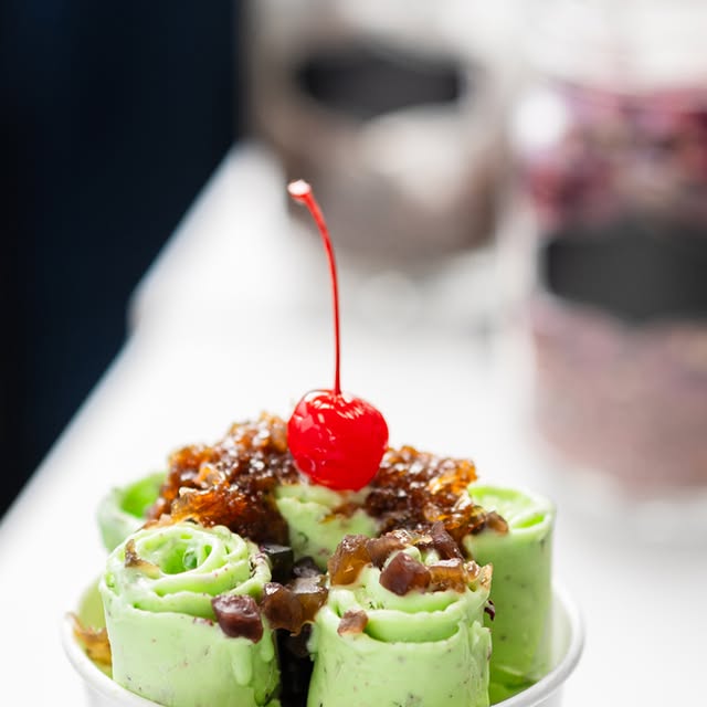 Mint chocolate chip rolls with brownie crumble and cherry topping